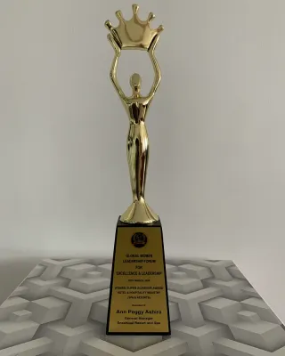 Gold figure trophy holding a crown, Women Super Achiever Award